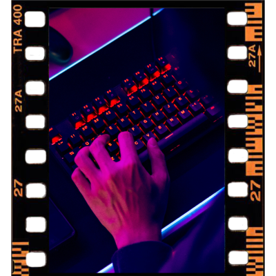 Film strip image containing an image of a person typing on a neon-lit keyboard